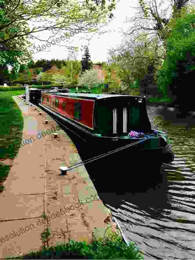 Narrowboat Moored Alongside A Tranquil Canal, Surrounded By Lush Vegetation And A Stone Bridge Narrowboat Dreams: A Journey North By England S Waterways